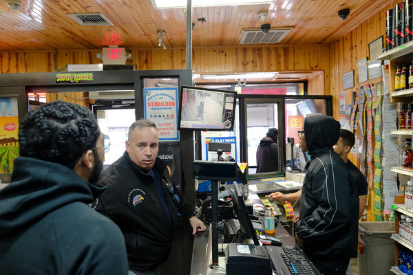 Gomez and Hernandez examining surveillance footage in a liquor store, in an effort to acquire evidence that might help Hernandez.